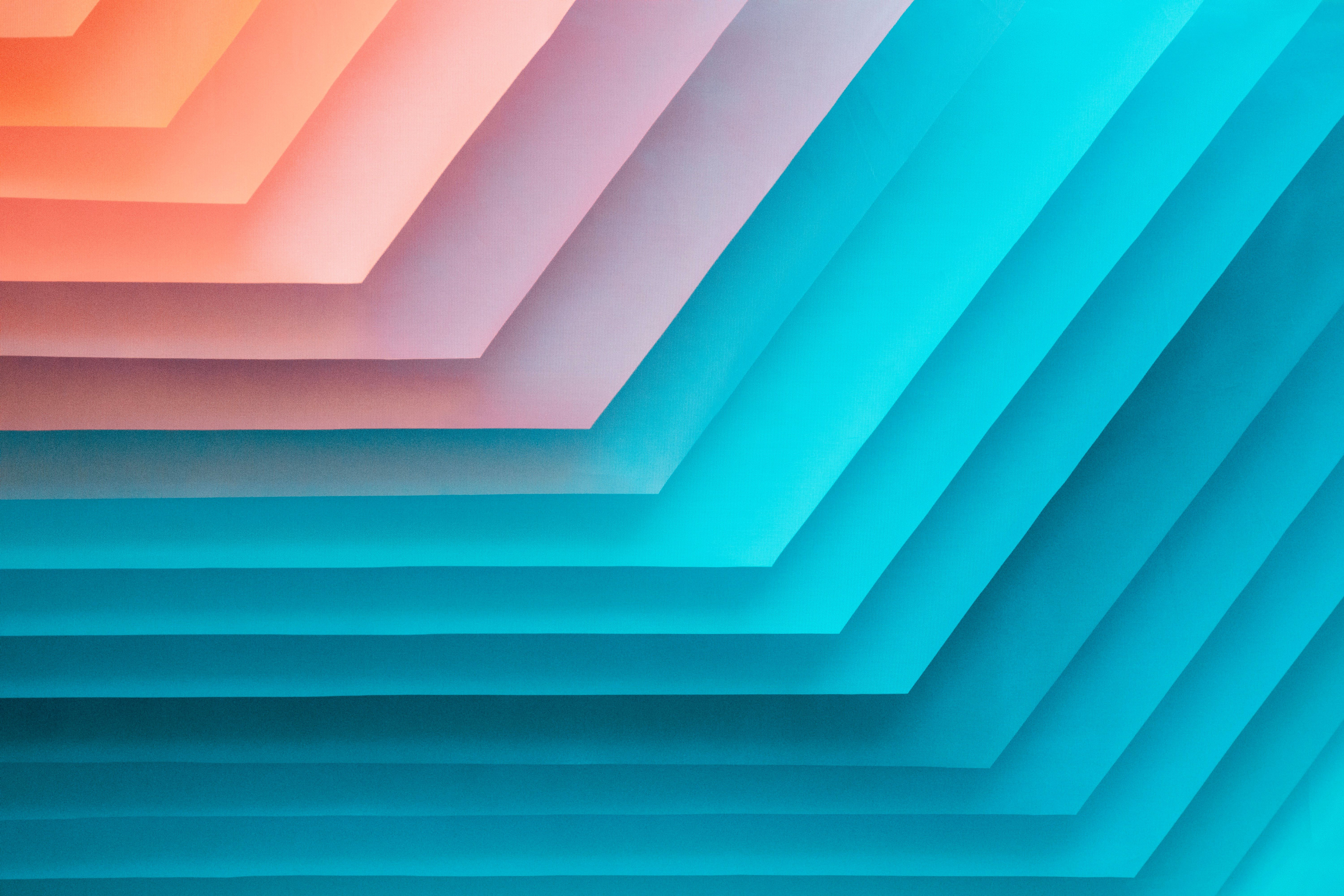 Turquoise and coral layered geometric shapes for Careers and Hiring